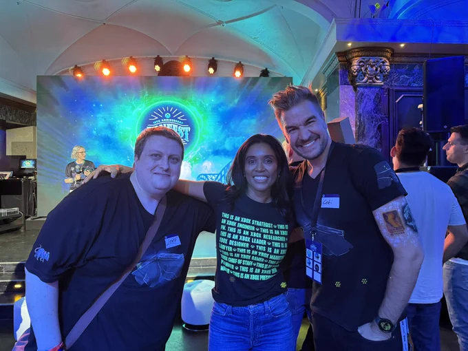Sarah Bond with Leator and LokiJimmyB at Xbox FanFest celebrating its 10th anniversary, posing in front of a vibrant event backdrop.