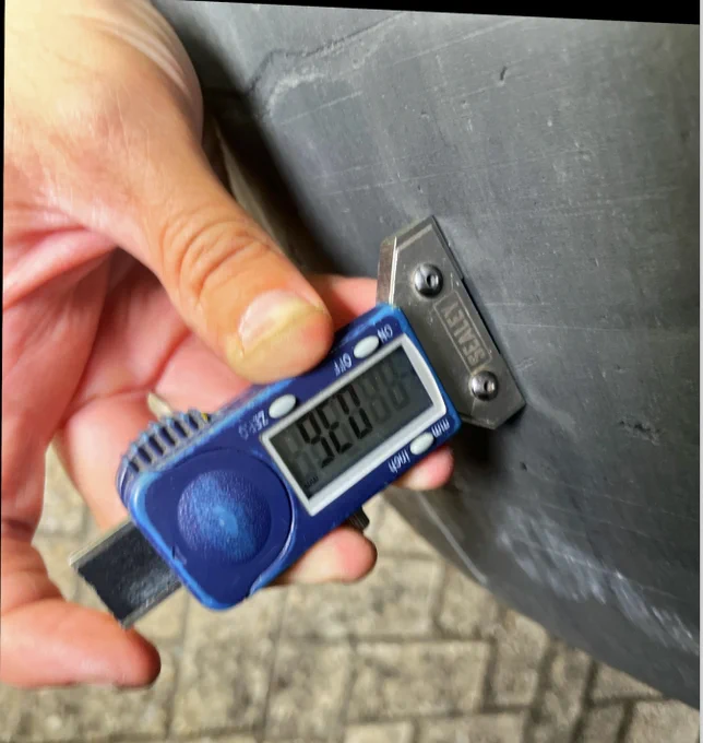 Tyre gauge showing no legal tread depth
