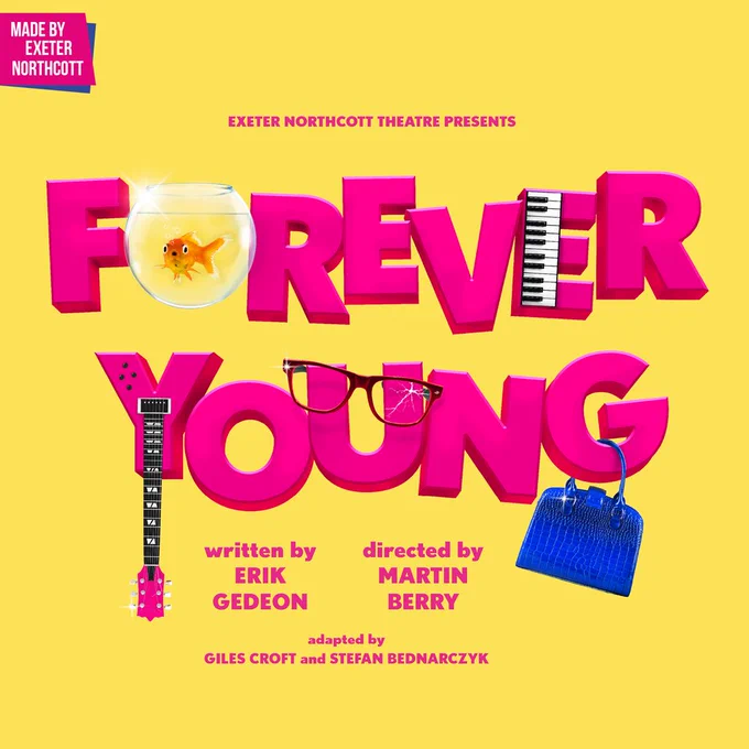 Yellow background. Pink text reads 'FOREVER YOUNG'. The first 'O' is a goldfish bowl. The second 'E' is half keyboard. The tail of the 'Y' is the neck of a guitar. A blue handbag hangs on the 'G'. Smaller text reads 'Exeter Northcott Theatre presents... Written by Erik Gedeon, directed by Martin Berry.'