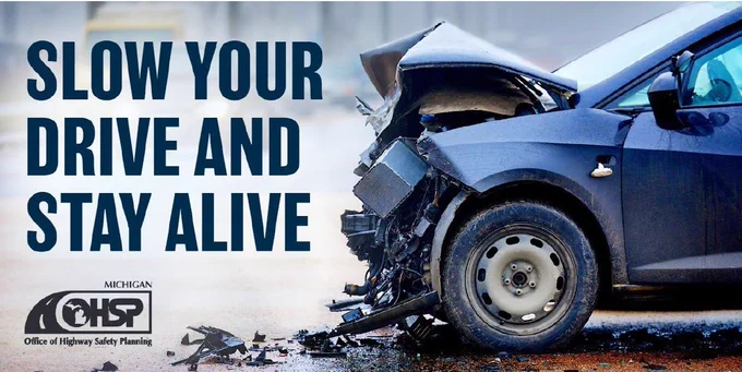 Image of a crashed vehicle and the text "Slow Your Drive and Stay Alive."