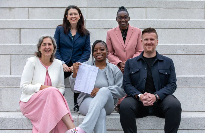 Mayor Caroline Woodley, Deputy Mayor Anntoinette Bramble and Cllr Anya Sizer, alongside a Cardinal Pole Catholic School student holding up their results and the school Headteacher