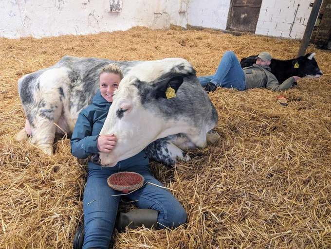 A smiling woman cuddling a cow at Dumble Farm, East Yorkshire, VisitEngland Awards for Excellence 2025 Gold Winner. Credit: Dumble Farm