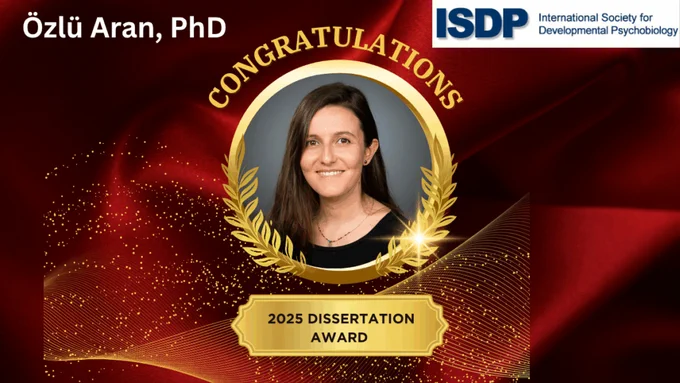 Portrait of Dr. Özlü Aran smiling in a professional setting. She has received the 2025 Dissertation Award from the International Society for Developmental Psychobiology (ISDP) in recognition of her outstanding research in developmental psychobiology. The image may include her name, affiliation with Northeastern University, and a visual element representing the award or ISDP branding.