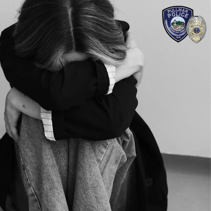 Photo of someone hugging their knees, with their head tucked into their arms.