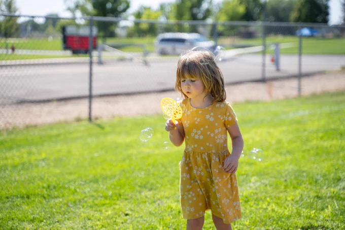 student blows bubbles