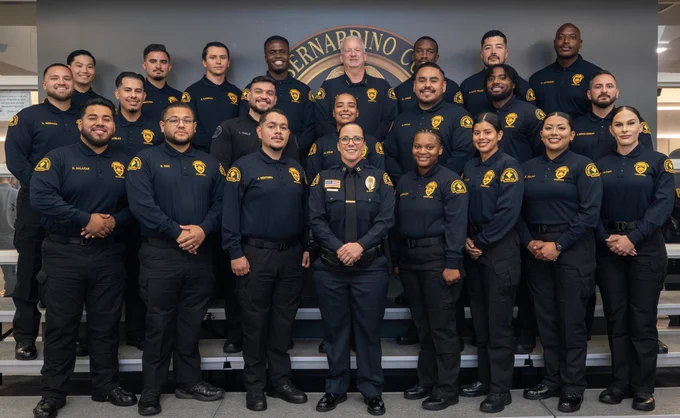 A group of probation officers posing together for a graduation celebration photo.
