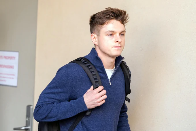 Photo of DOGE staffer Nate Cavanagh in a blue pullover, carrying a black backpack.