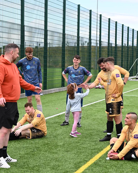 A group of footballers playing.
