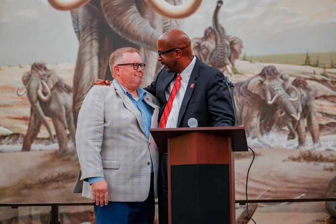 Mike Zeleny and Chancellor Rodney D. Bennett hug during Zeleny’s farewell reception in Morrill Hall.