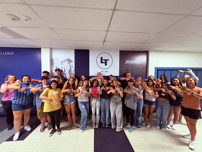 Group of high school students making a LT with their hands