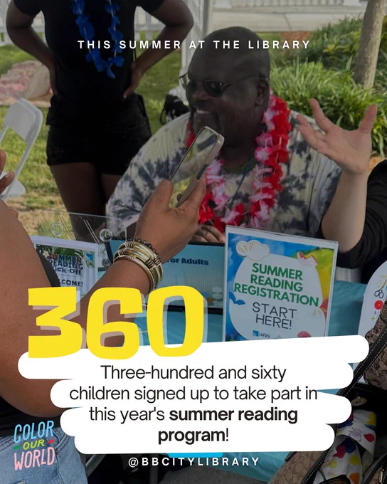 Smiling man wearing sunglasses and a red lei sits at a table with a “Summer Reading Registration Start Here!” sign while someone registers on their phone. Large text reads “360 – Three-hundred and sixty children signed up to take part in this year’s summer reading program!” Boynton Beach City Library logo and “Color Our World” branding included