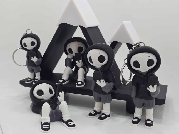 Five “Project Hazy” figures, including two keychains, posed on a black 3D printed platform with stylized white mountain peaks in the background.