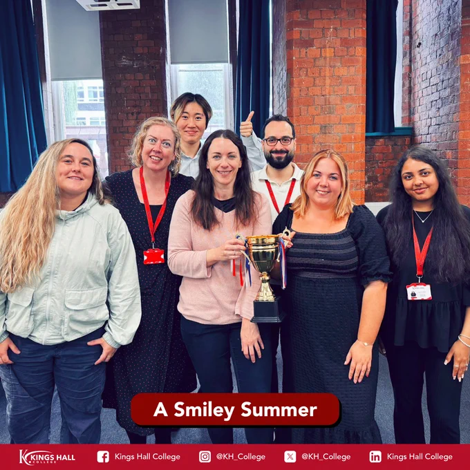 An image of Kings Hall College’s Summer Programme staff holding a trophy. At the bottom of the image is a red box with the words ‘A Smiley Summer’ in white. At the bottom of the image are the social media handles for Kings Hall College:
Facebook: Kings Hall College
Instagram: @KH_College
X:  @KH_College
LinkedIn: Kings Hall College