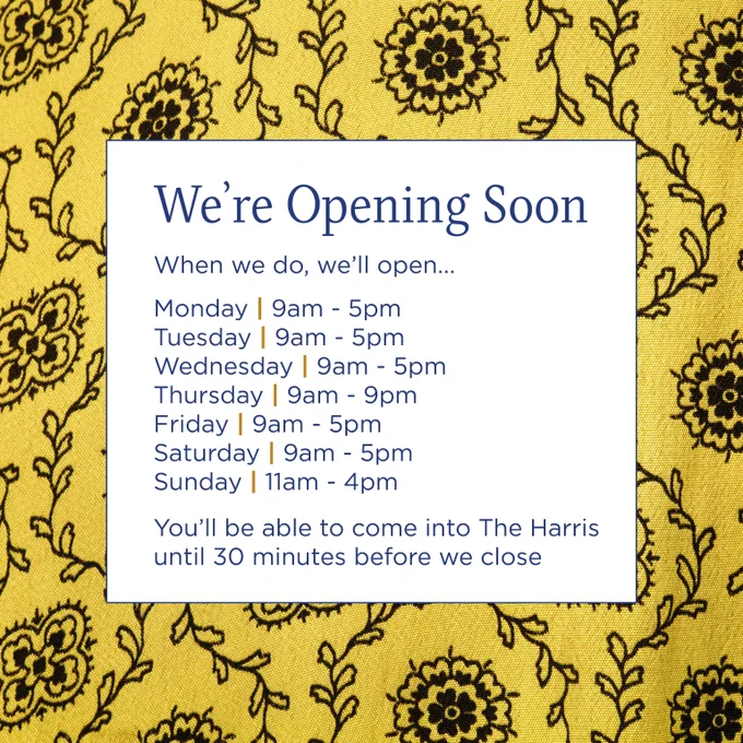 Sign announcing The Harris opening soon with hours Monday to Saturday 9am-5pm, Thursday extended to 9pm, Sunday 11am-4pm.