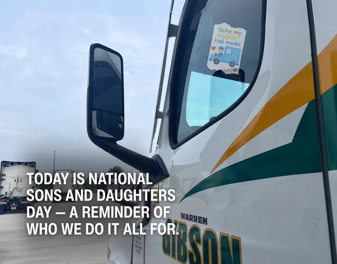 A Warren Gibson truck is parked with a child's drawing displayed in the window, reading "You're my biggest role model" next to an illustration of a truck. The image includes the text: "Today is National Sons and Daughters Day — a reminder of who we do it all for."
