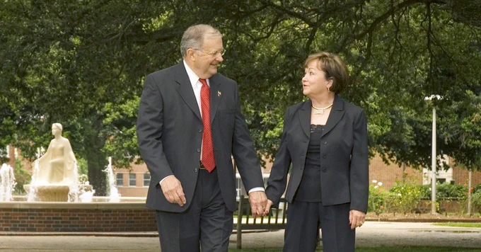 Dr. Dan Reneau and wife Linda walk hand-in-hand through the Quad on Louisiana Tech's campus.