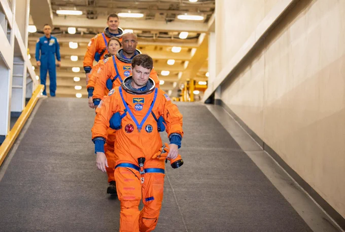 NASA’s Artemis II crew members (front to back) NASA astronauts Reid Wiseman, Victor Glover, and Christina Koch, and CSA (Canadian Space Agency) astronaut Jeremy Hansen descend the well deck of the USS San Diego as NASA’s Exploration Ground System’s Landing and Recovery team and partners from the Department of Defense aboard the ship practice recovery procedures using the Crew Module Test Article, during Underway Recovery Test 11 (URT-11) off the coast of San Diego, California on Feb. 25, 2024. Credit: NASA/Isaac Watson