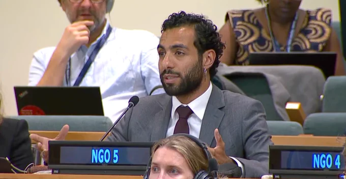 Image of a man speaking into a microphone.