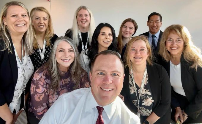 Contra Costa County Administrator’s Office employees pose for a selfie in the County Administration Building in Martinez, California.
