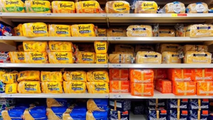 Supermarket shelves filled with bread.