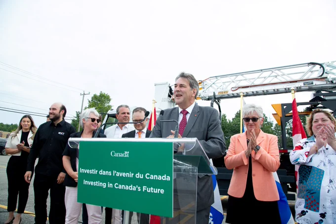 Parliamentary Secretary Claude Guay delivers a speech at a podium.