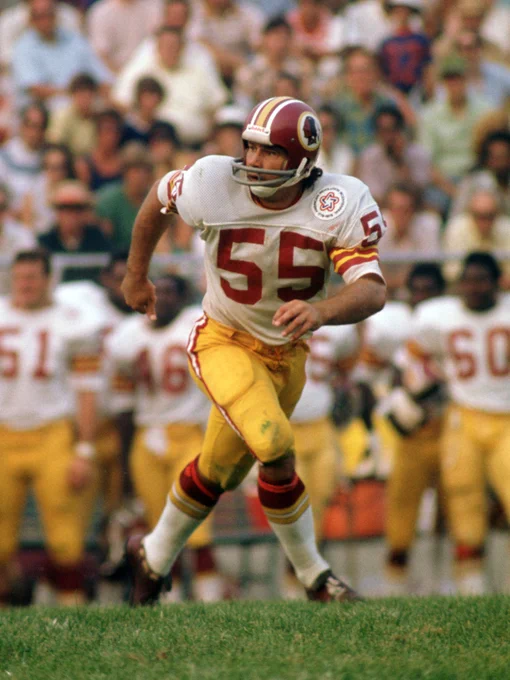 Photo of Chris Hanburger. He is wearing a burgundy helmet, white jersey and gold pants.