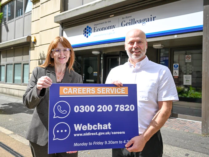 A photo of the Minister and the head of the careers service holding a sign with details on how to 