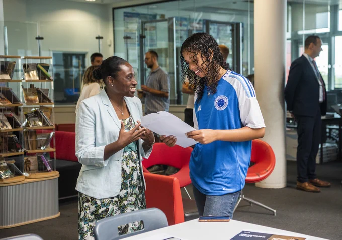 Deputy Mayor Bramble congratulates a student at Skinners Academy