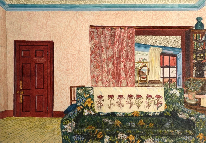 Cosy living room with a floral patterned green sofa, a red wooden door, and a window framed by red curtains revealing a decorated interior space.