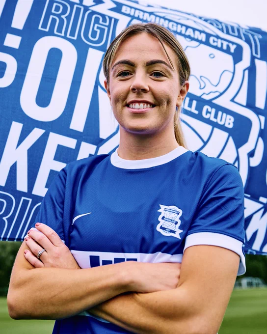 Simone Magill stands in front of a Blues fan with her arms crossed.