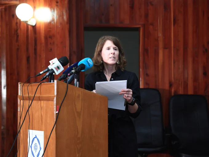 VCU professor Amy Rector speaks at a lectern during a news conference in Ethiopia.
