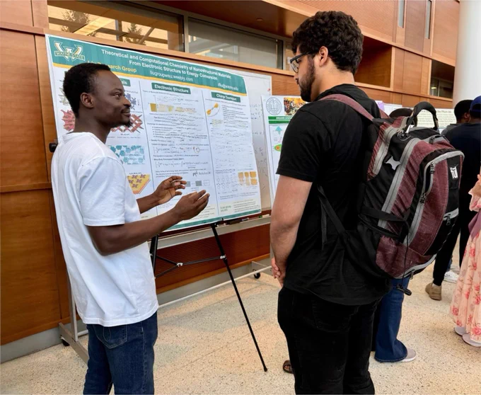 2 people discussing a research poster