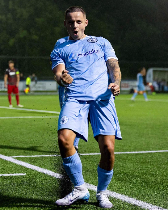 Calum Bateman celebrates scoring for Cambrian United against Treowen Stars.