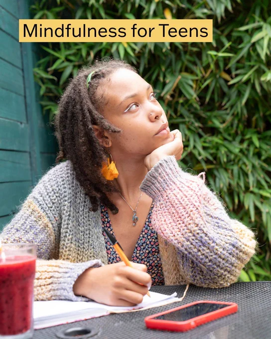A teen girl looks contemplative while writing in a journal outside. The text says, "mindfulness for teens."