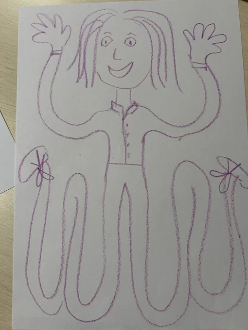 Photograph of a self portrait created using as much space on the white A4 page as possible. Image in purple crayon
