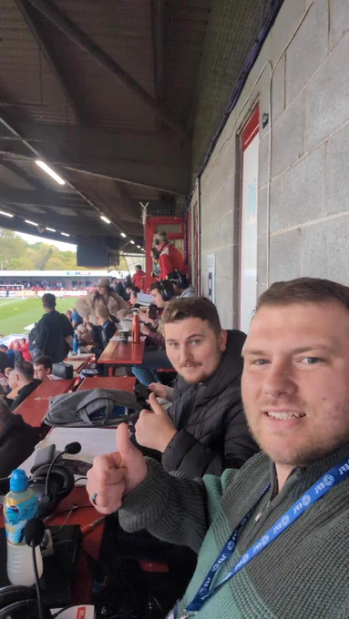 A picture of two Crawley town ADC Commentators with the broadcast equipment on the desk and view of the press area.