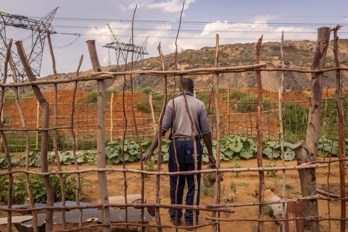  Man walks through a plot of land where he has began farming vegetables which he donates to the church in Witbank, Emalahleni on November 28, 2023. Credit: Gulshan Khan / Climate Visuals