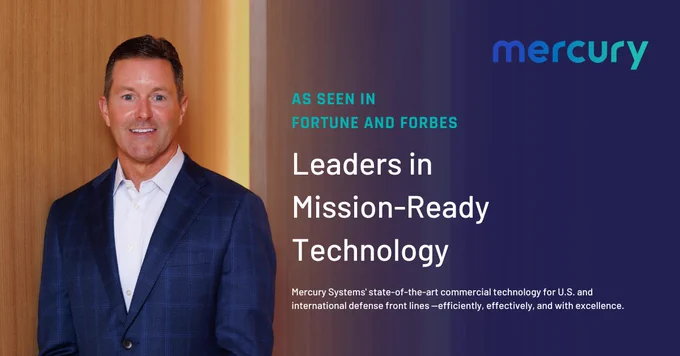 Man in a blue checkered suit and white shirt standing against a wood-paneled wall with Mercury branding and text about mission-ready technology.