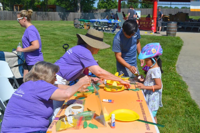 A child creates at a craft station