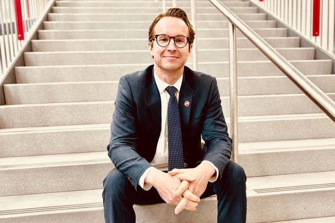 Justin Kaiser sits on a staircase