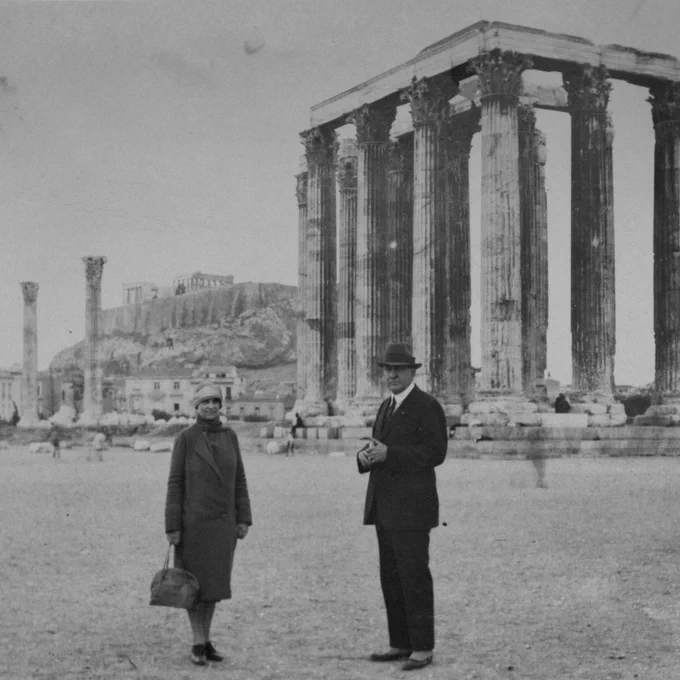 Two people standing in front a historical structure.