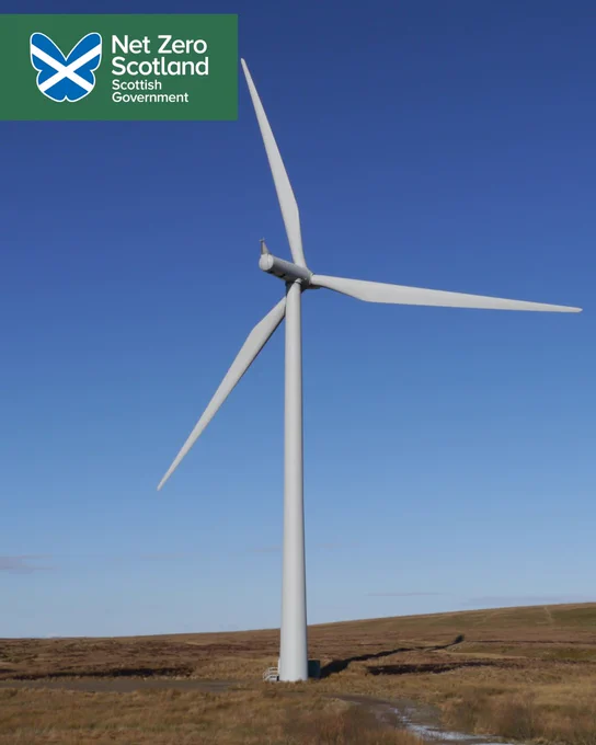 A photo of an onshore wind turbine in Scotland, in the distance is blue skies