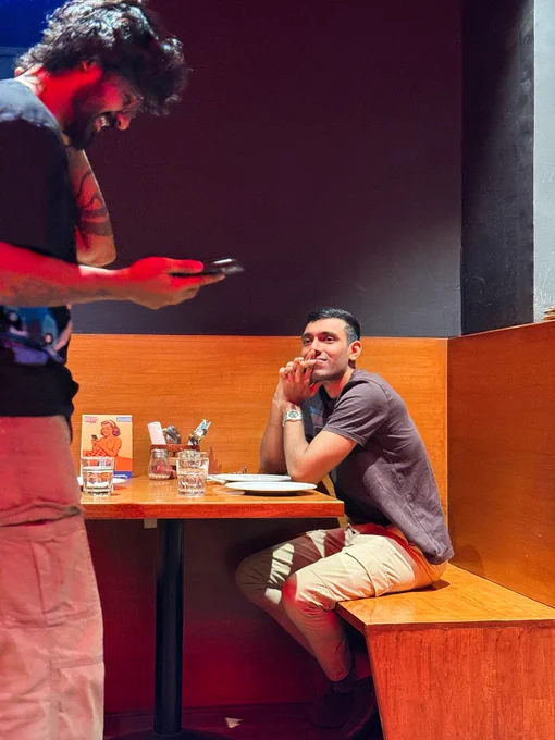 Two handsome men sitting at a diner, Cryptic Comet.