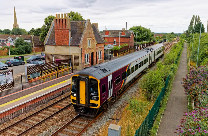 EMR's Pride liveried Class 158/7 No158773 passing Bottesford Station with a Liverpool to Norwich Service