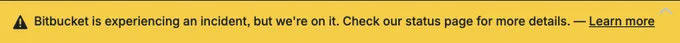Screenshot of a banner saying "Bitbucket is experiencing an incident, but we're on it. Checkout our status page for more details. -- Learn more (link)" in the most-obnoxious, glaring yellow ever rendered in a UI.