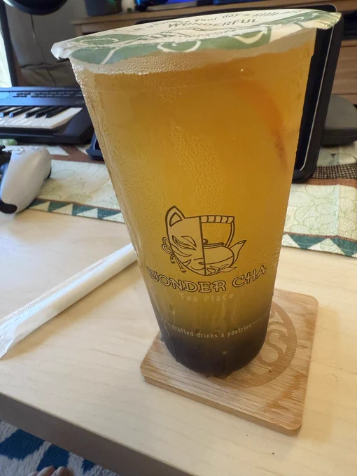 Cup of citrus kumquat oolong tea with honey boba.