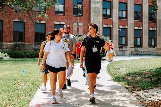 A group of students tour campus with CAST during Big Red Welcome