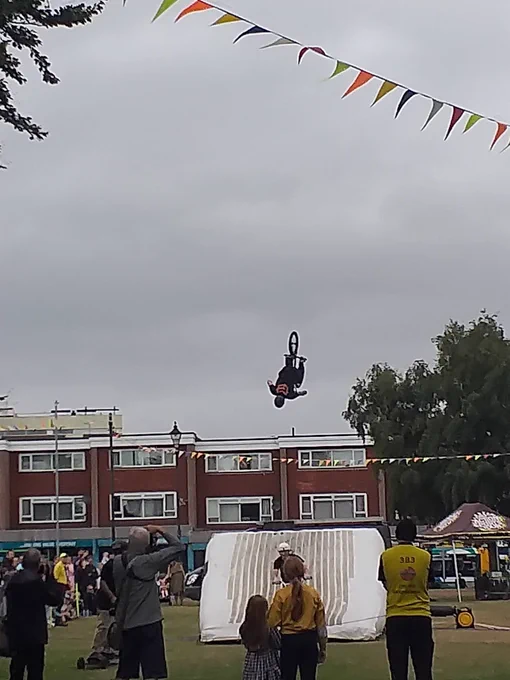 Actions sports tour rider performing a backflip on a BMX 