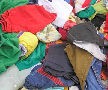 A table full of clothes folded. 