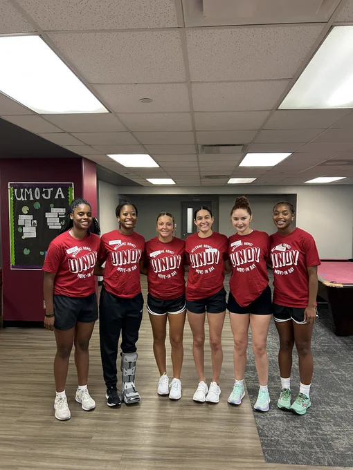 Several UIndy women’s basketball players pose for a picture while helping on student move-in day.
